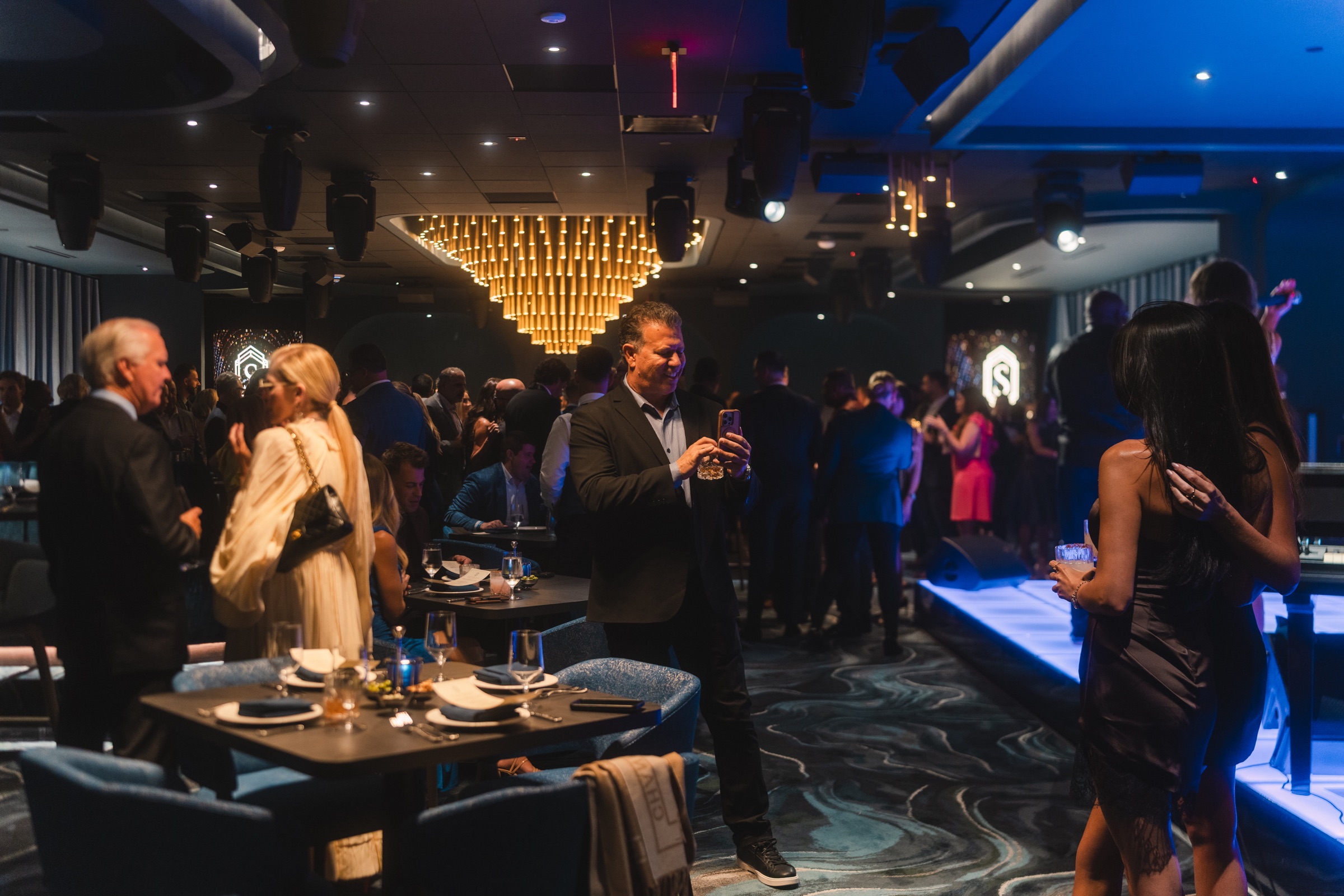 Guests gathering in a dramatic upscale dining room