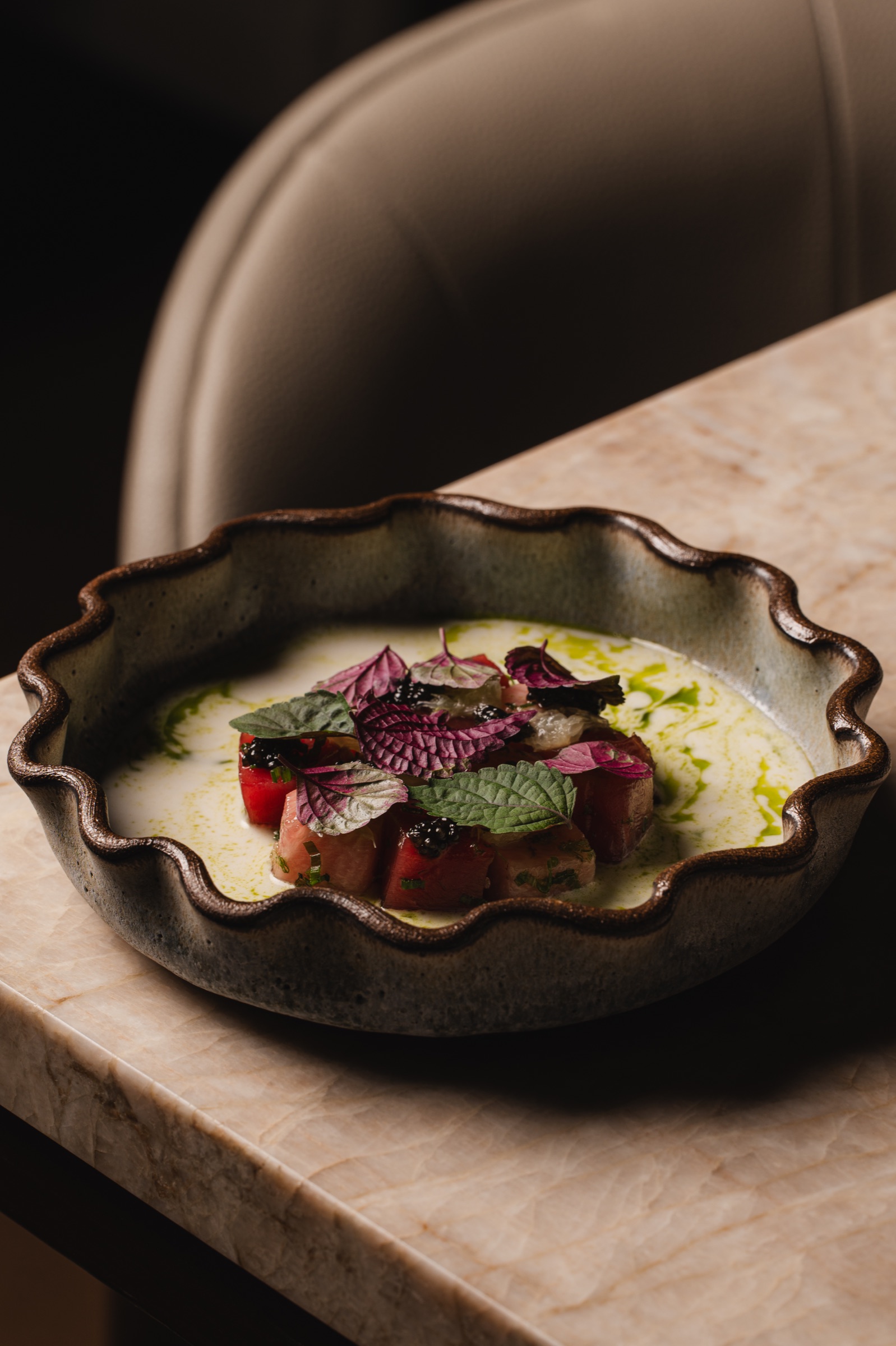 Composed tuna dish served in a sculptural ceramic bowl